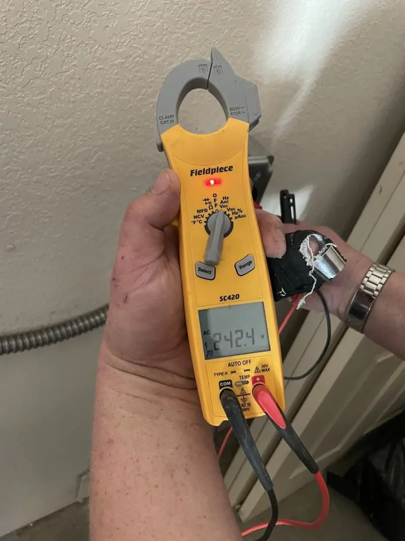 Voltage testing with clamp meter during Ceiling Fan Installation in Durham